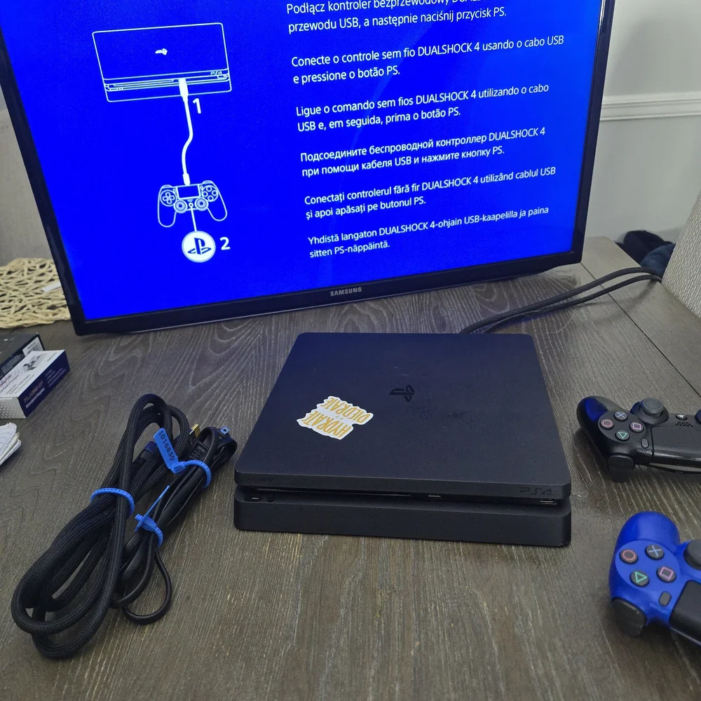 Sony PlayStation 4 Console with Black and Blue Controllers